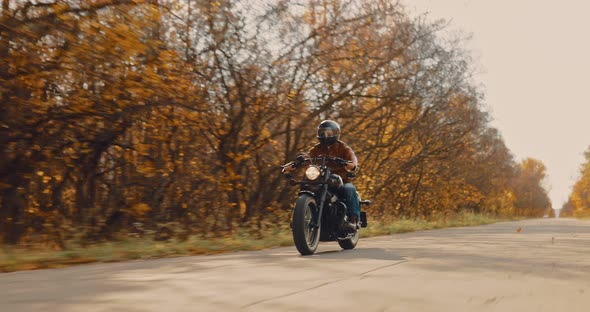 Guy in a Helmet Rushes Along the Track Along the Forest