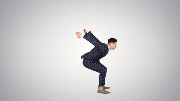 Businessman Makes a Back Flip and Shows Cool Gesture To Camera After on Gradient Background.