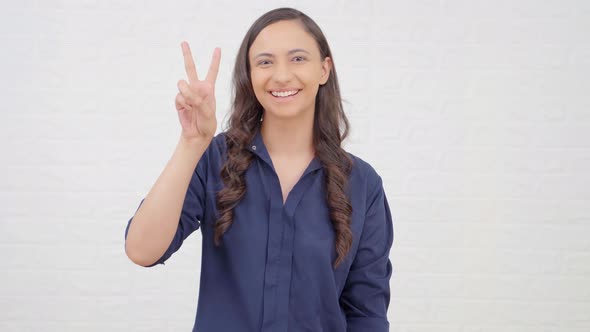 Indian girl showing Peace sign
