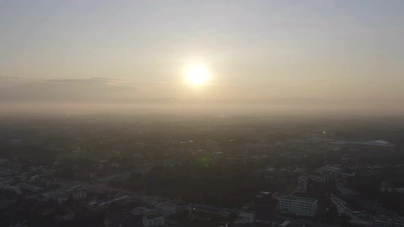 Aerial view of Chiang Mai Downtown Skyline with fog and the sun, Thailand. Financial district