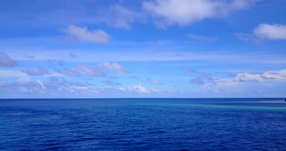 Beautiful fly over travel shot of a summer white paradise sand beach and blue sea background in hi r