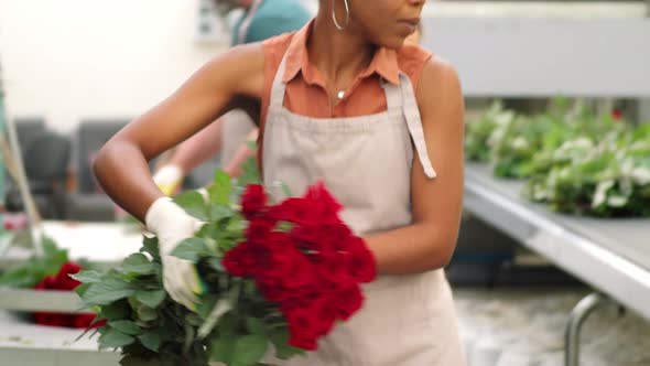 African American Woman Working with Roses at Flower Factory