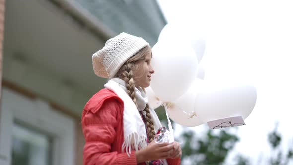 Side View Portrait Smiling Charming Teenage Girl Standing Outdoors Holding White Balloons with