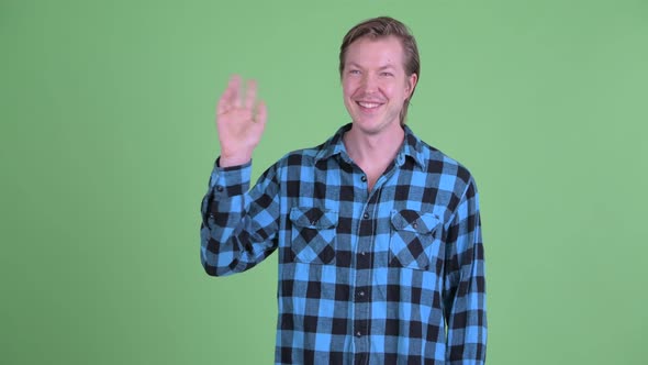 Happy Young Handsome Hipster Man Waving Hand