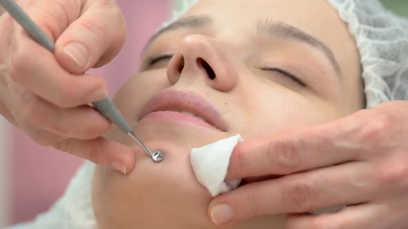 Cosmetologist Cleaning Face Close Up