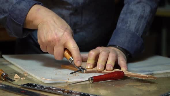 Craftman Cuts the Leather for Make a Bag