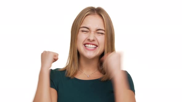 Headshot of Happy Woman Being Ecstatic About Reaching Goals Clenching Fists in Pleasure Acting Like