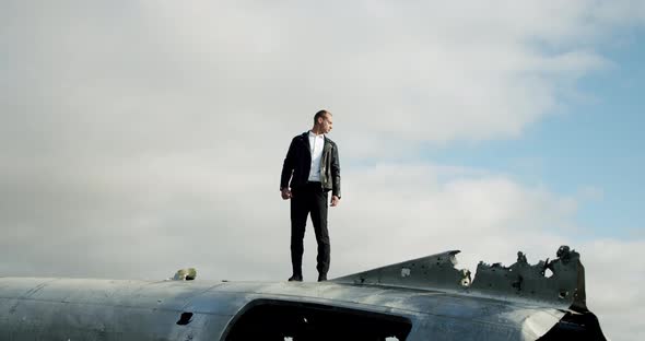 Man Stand on the Old Crashed Plane Abandoned on Solheimasandur Beach Near Vik in Iceland.