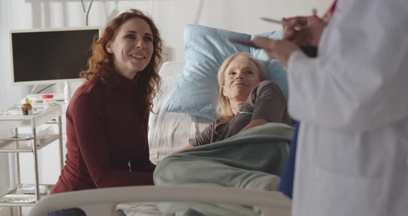 Doctor Discussing Happy News About Recovery with Aged Female Patient and Her Daughter