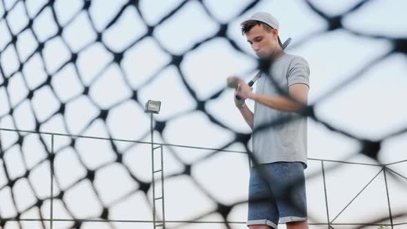 Young Tennis Player Playing with a Tennis Ball, Tune in To the Upcoming Game