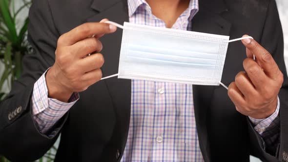 Businessman Hand Holding Surgical Face Mask Close Up