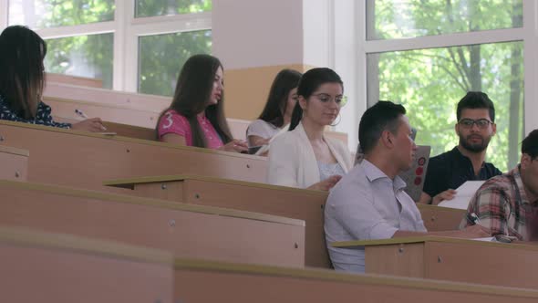 Side View of Multiracial Students Preparing for Lecture