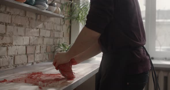 Potter Kneads Clay with Dye in Slow Motion Pottery at Workshop Potter Prepares Clay for Making