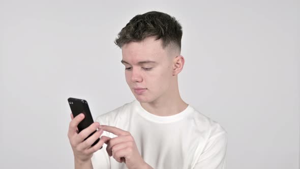 Young Man Browsing Smartphone on White Background