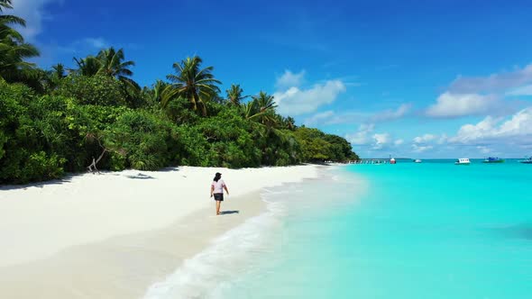 Lady tans on tropical seashore beach lifestyle by blue lagoon with white sandy background of the Mal