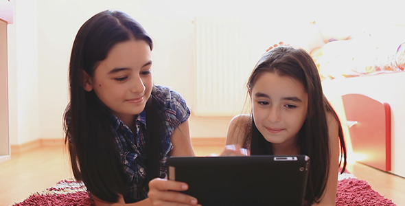 Two Happy Teenage Girls Using Using Tablet 3