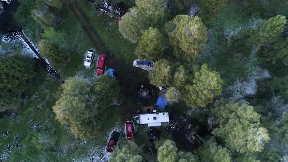 Rising aerial view above people camping in the forest in Idaho