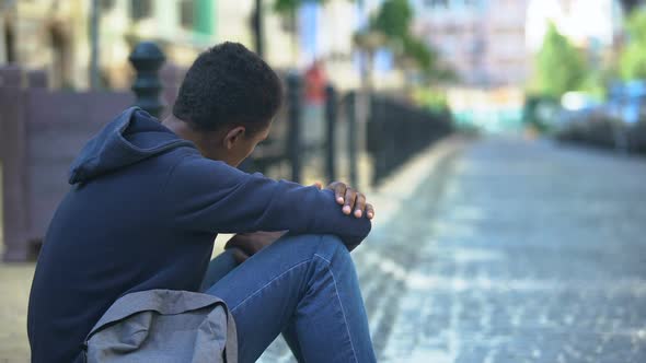 Sad Mixed-Race Teenager Sitting on Sidewalk, Relationship Problems, Awkward Age