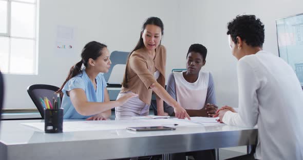 Group of diverse businesswoman talking, smiling and working together in office