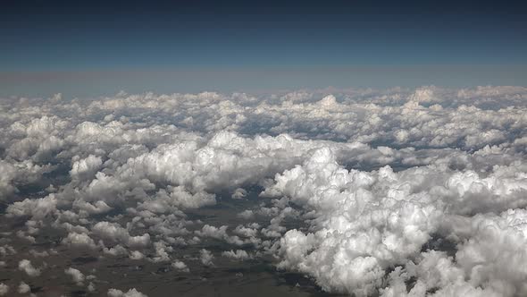 Airplane View of Partly Cloudy and Cumulus Clouds Condensed in Clusters in Humid Warm Air