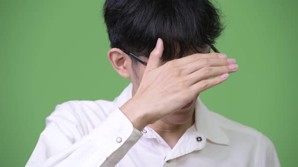 Young Asian Businessman Covering Eyes Not Wanting To Look