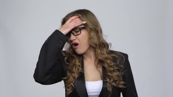 Business Woman Suffering From Headache From Fatigue Against Grey Background