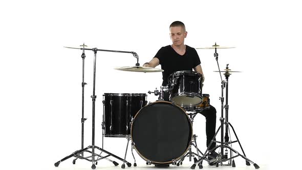 Energetic Professional Musician Plays Good Music on Drums, White Background, Slow Motion