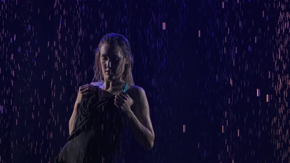 Silhouette of a Woman Performing an Element of Bachata Dance of the Among the Raindrops. Black