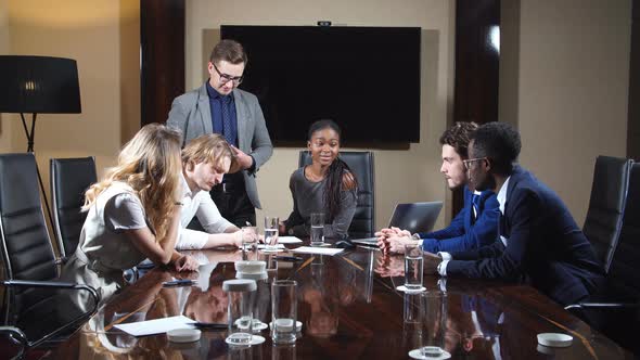 Coworkers Laughing Together During A Meeting.