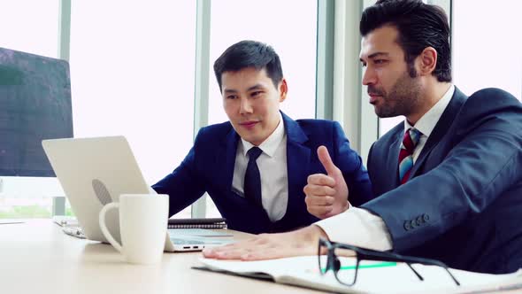 Two Business People Talk Project Strategy at Office