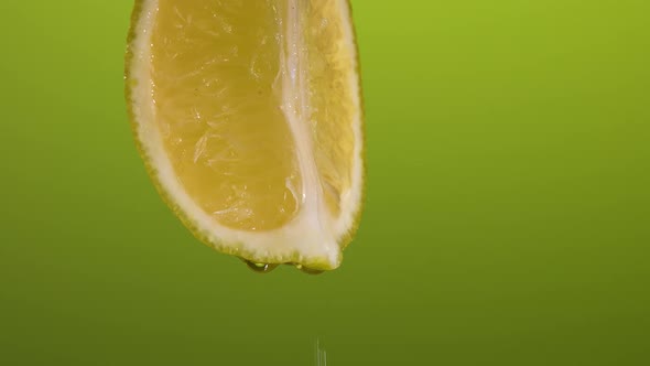 Fresh Lemon on a Green Background