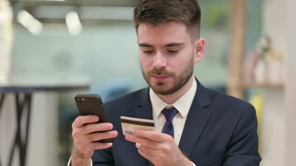 Young Businessman Making Online Payment on Smartphone