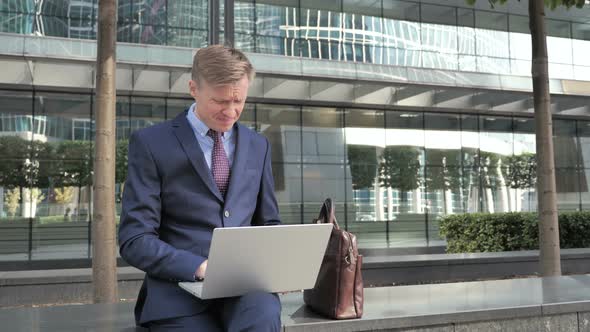 Businessman Frustrated by Results, Sitting Outside Office