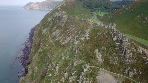 Tracking and panning aerial from right to left clearly picks out the famous southwest coast path hal