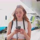 Young woman using smartphone looking camera positive and trustful in future - VideoHive Item for Sale