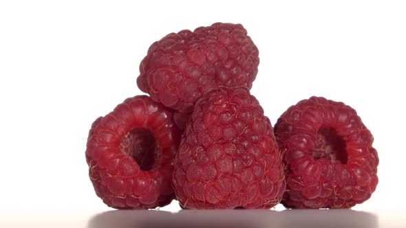 Raspberry Fruit Is Revolve on a White Background. Close Up