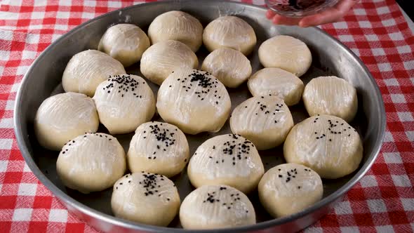 Sprinkling Black Sesame on Bread