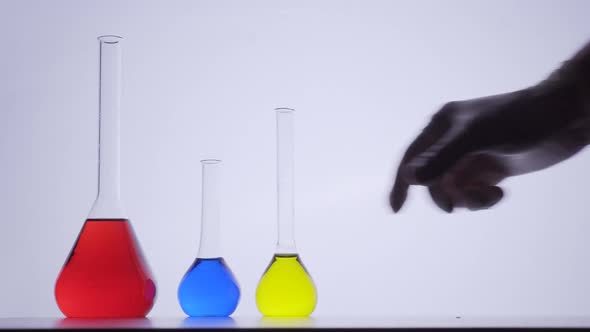 Laboratory assistant put colorful flasks bulbs on table. Researching coronavirus	