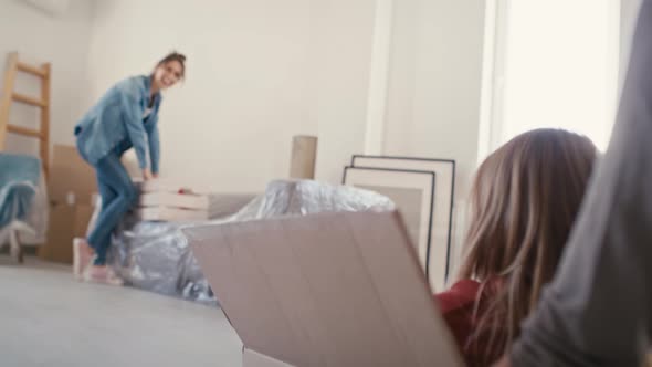 Father pushing little girl in paper box while moving house. Shot with RED helium camera in 8K.