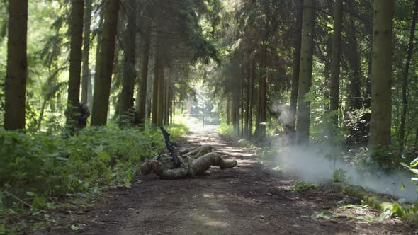 Combat Medic Evacuating Wounded Soldier From Point of Injury in Forest