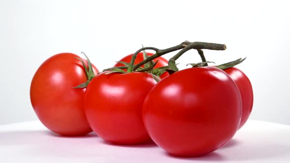 Tomatoes rotating on white background