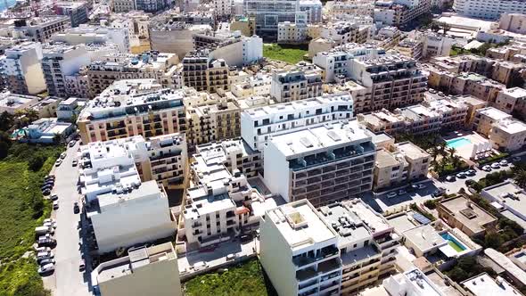 Vibrant city downtown of St. Paul Bay in Malta island, aerial view