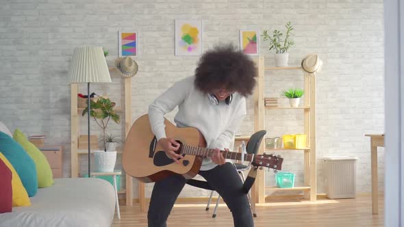 African American Woman with an Afro Hairstyle Expressive Playing on the Guitar Slow Mo