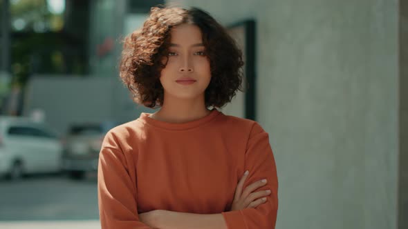 Portrait of Confident Young Indian Business Woman in casual clothes looking at camera arm cross