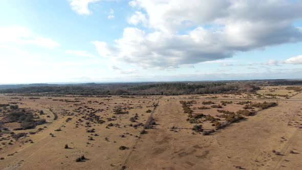 Drone shot rising over a beautiful British countryside landscape in summer sun