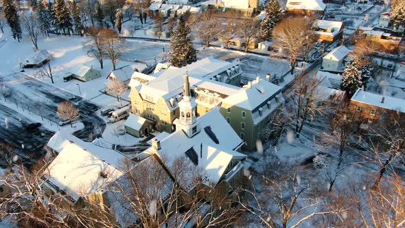 AERIAL Large Snow Covered Building During Snowstorm