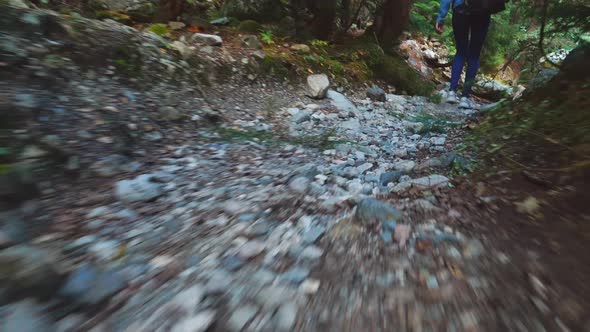 young tourist walks through mountainous area and looks at beautiful landscape.