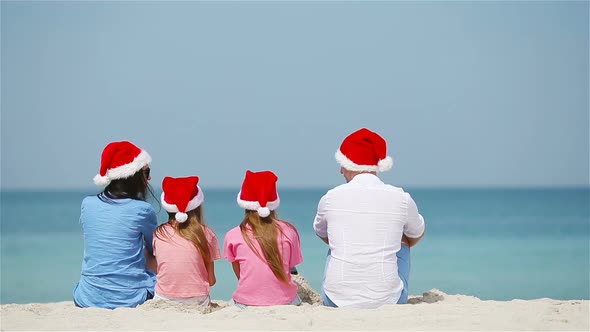 Happy Family on the Caribbean Beach Celebrating Christmas Vacation