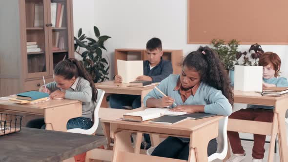 Smart Schoolgirl Answering Question in Class