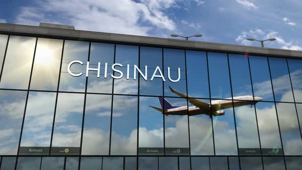Airplane landing at Kishinev, Chisinau Moldova airport mirrored in terminal